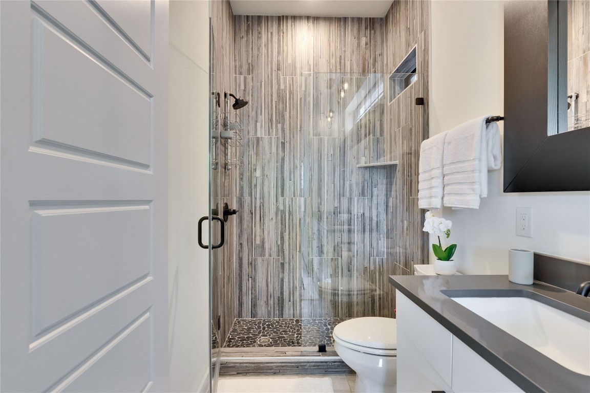 808 Lydia Street Austin, TX 78702 - Photo 28 of 40 a bathroom with a granite countertop sink toilet and shower