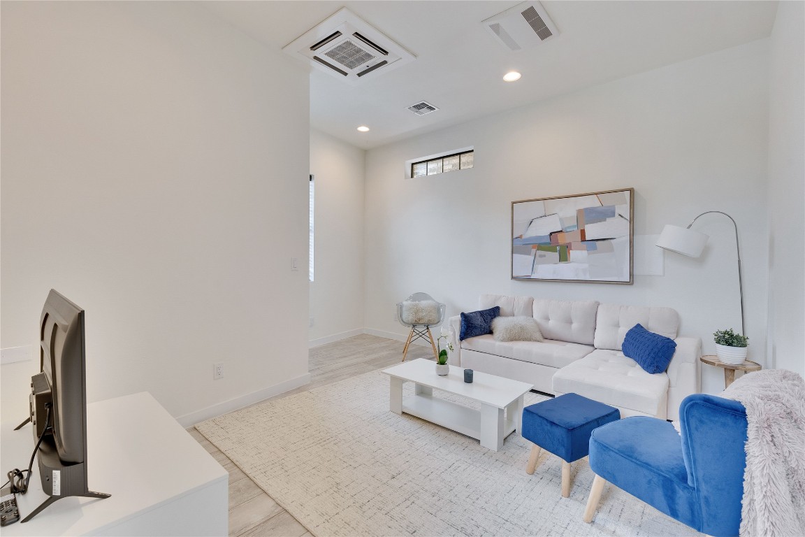 808 Lydia Street Austin, TX 78702 - Photo 3 of 40 a living room with furniture a rug and a flat screen tv