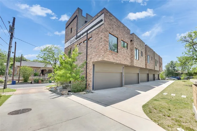 a front view of a house with plants