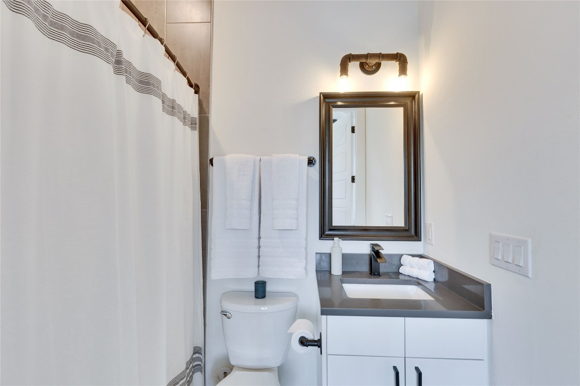 808 Lydia Street Austin, TX 78702 - Photo 36 of 40 a bathroom with a sink a toilet and mirror