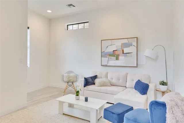 a living room with furniture and white walls