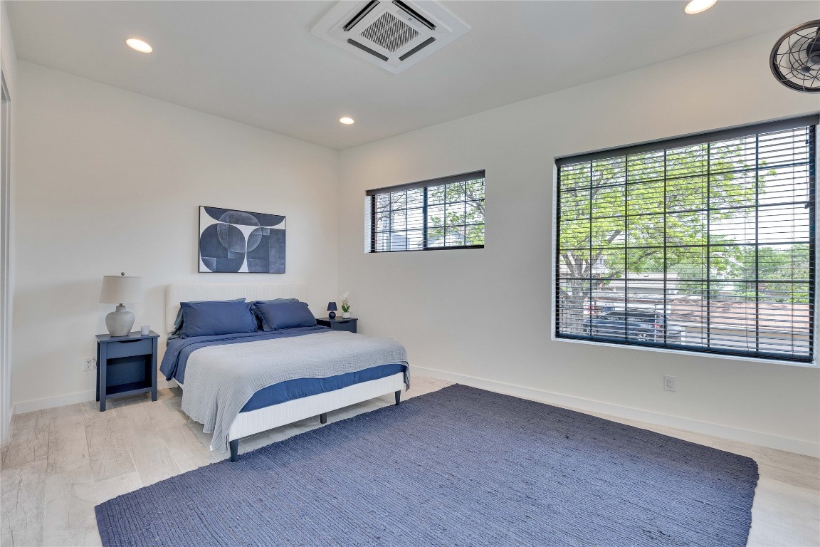 808 Lydia Street Austin, TX 78702 - Photo 8 of 40 a spacious bedroom with a large bed and a large window