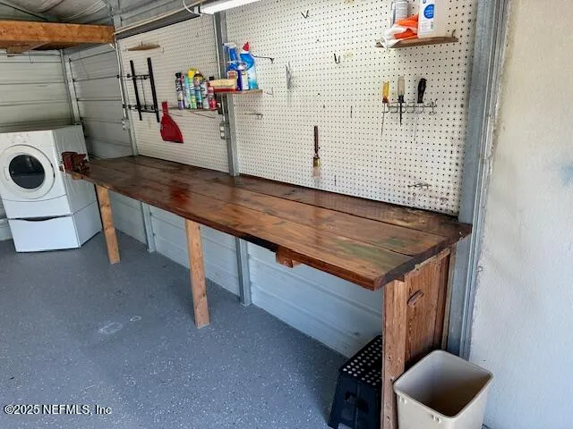 an empty room with a chandelier fan and windows