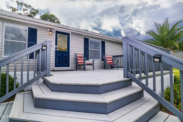 a view of a backyard with wooden fence