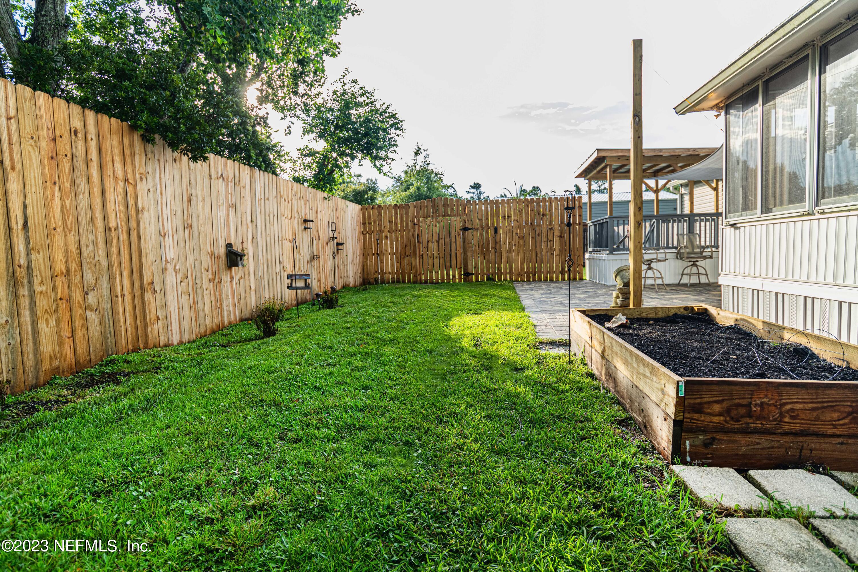 6681 Brown Road St. Augustine, FL 32095 - Photo 36 of 43 a view of a backyard with wooden fence