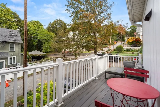 a view of a deck with furniture and a yard