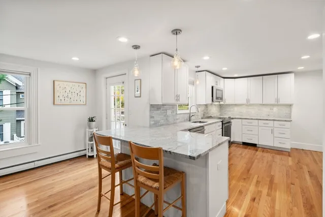 a kitchen with granite countertop white cabinets and counter space