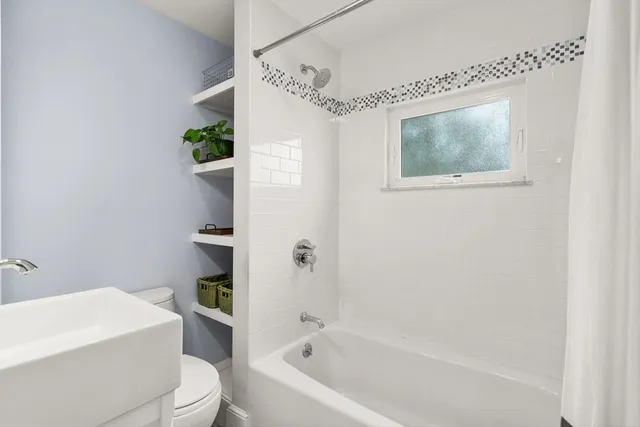 a bathroom with a toilet a sink and bathtub