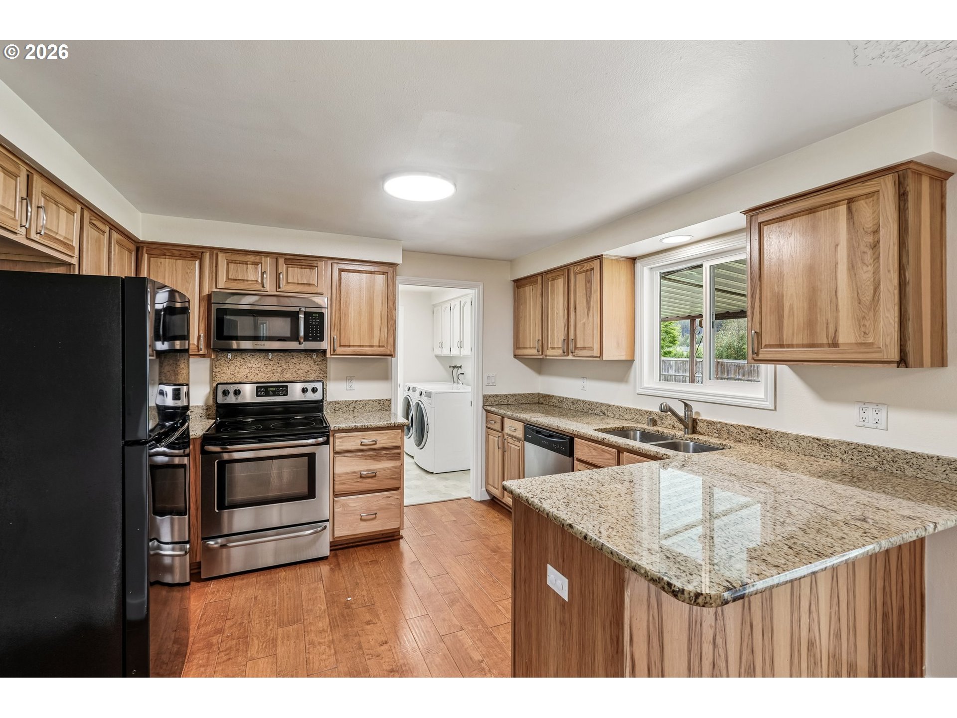 22600 Northeast 28th Street Camas, WA 98607 - Photo 10 of 48 a kitchen with stainless steel appliances granite countertop a sink stove microwave and refrigerator