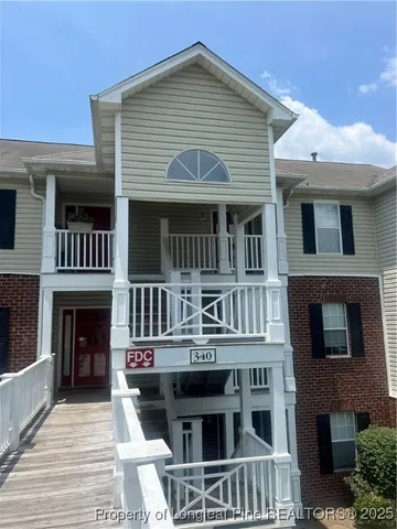 a front view of residential houses with stairs