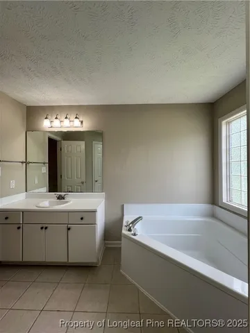 a bathroom with a bathtub and a sink