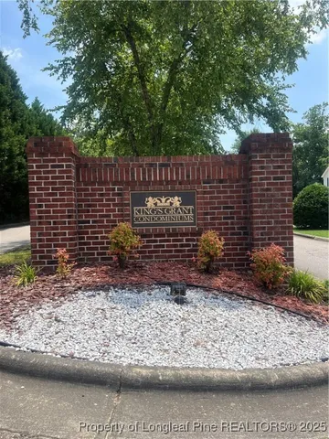 a view of a yard with wooden fence