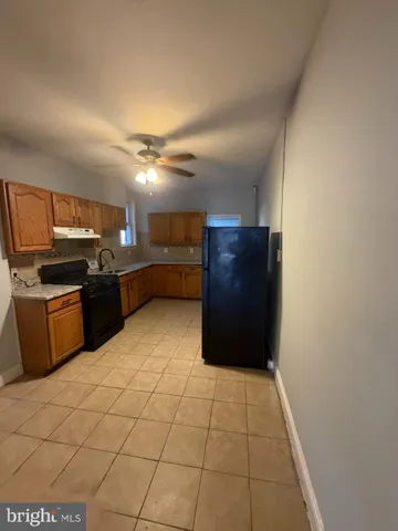 a kitchen with stainless steel appliances granite countertop a refrigerator and a stove