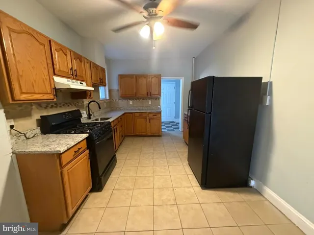 a kitchen with a refrigerator a stove top oven a sink and dishwasher