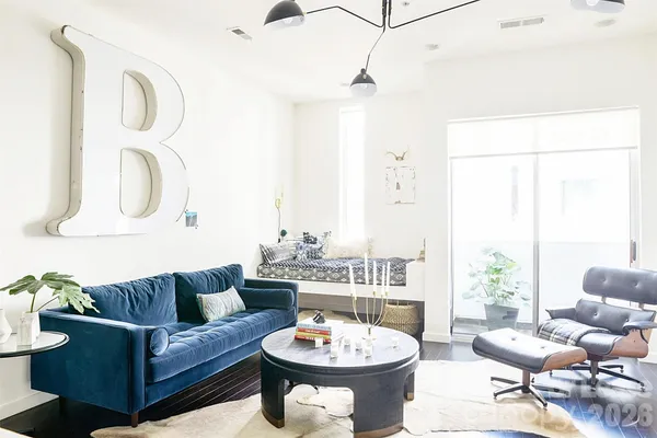 a living room with furniture a table and a potted plant