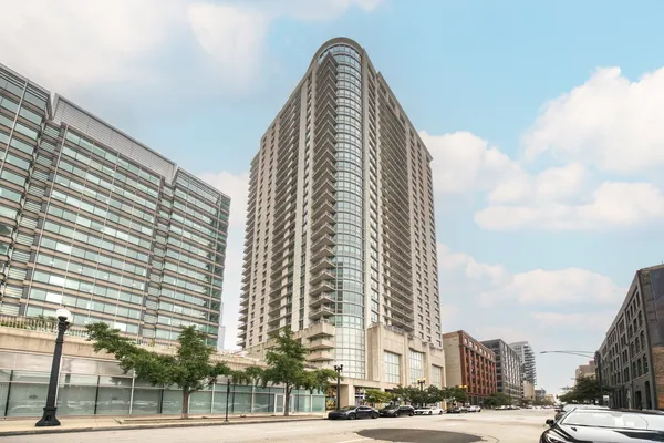 a view of a tall building next to a road