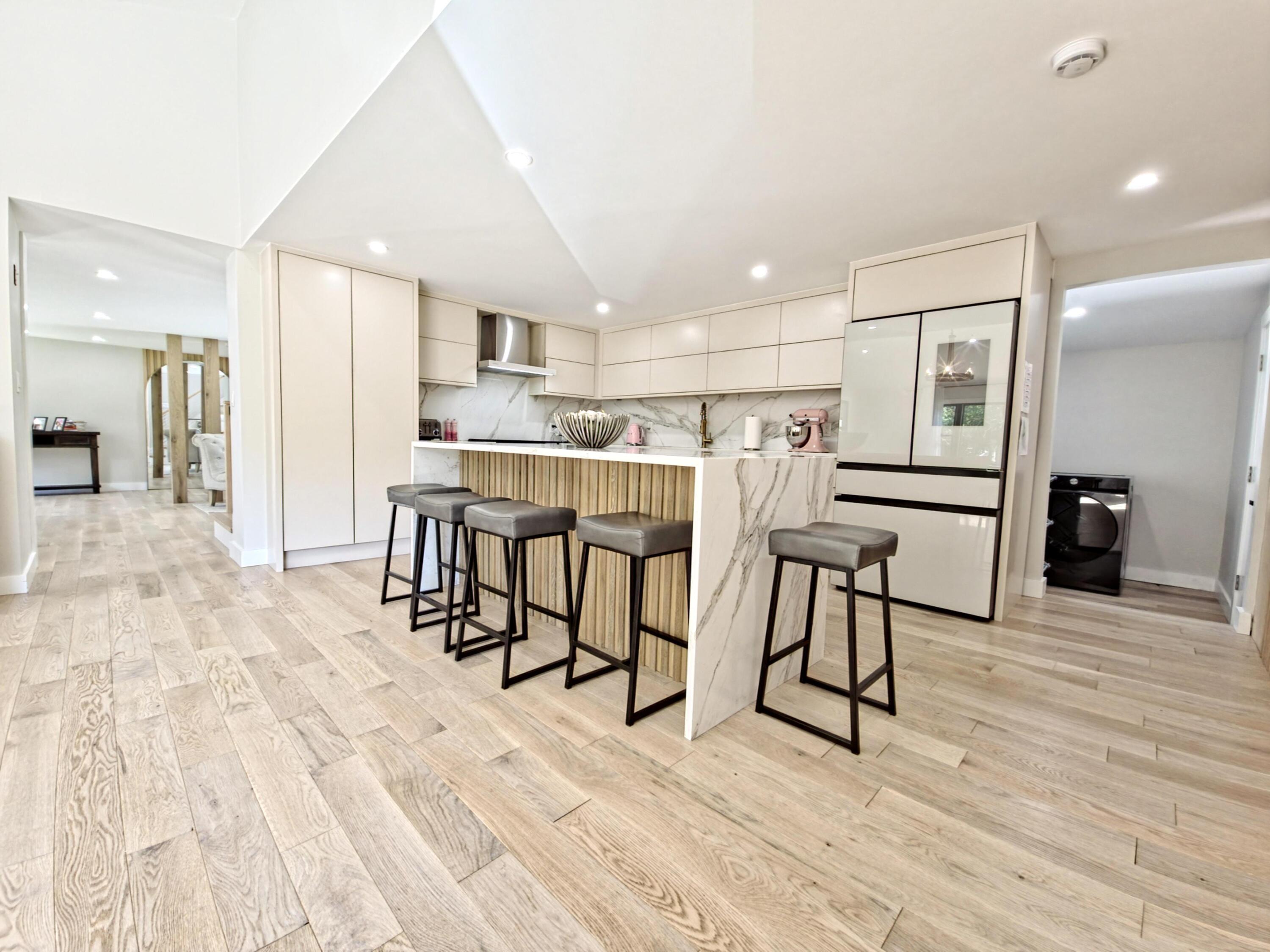 22 Keel Way Hyannis, MA 02601 - Photo 17 of 42 a view of a kitchen with kitchen island a dining table chairs stainless steel appliances and cabinets