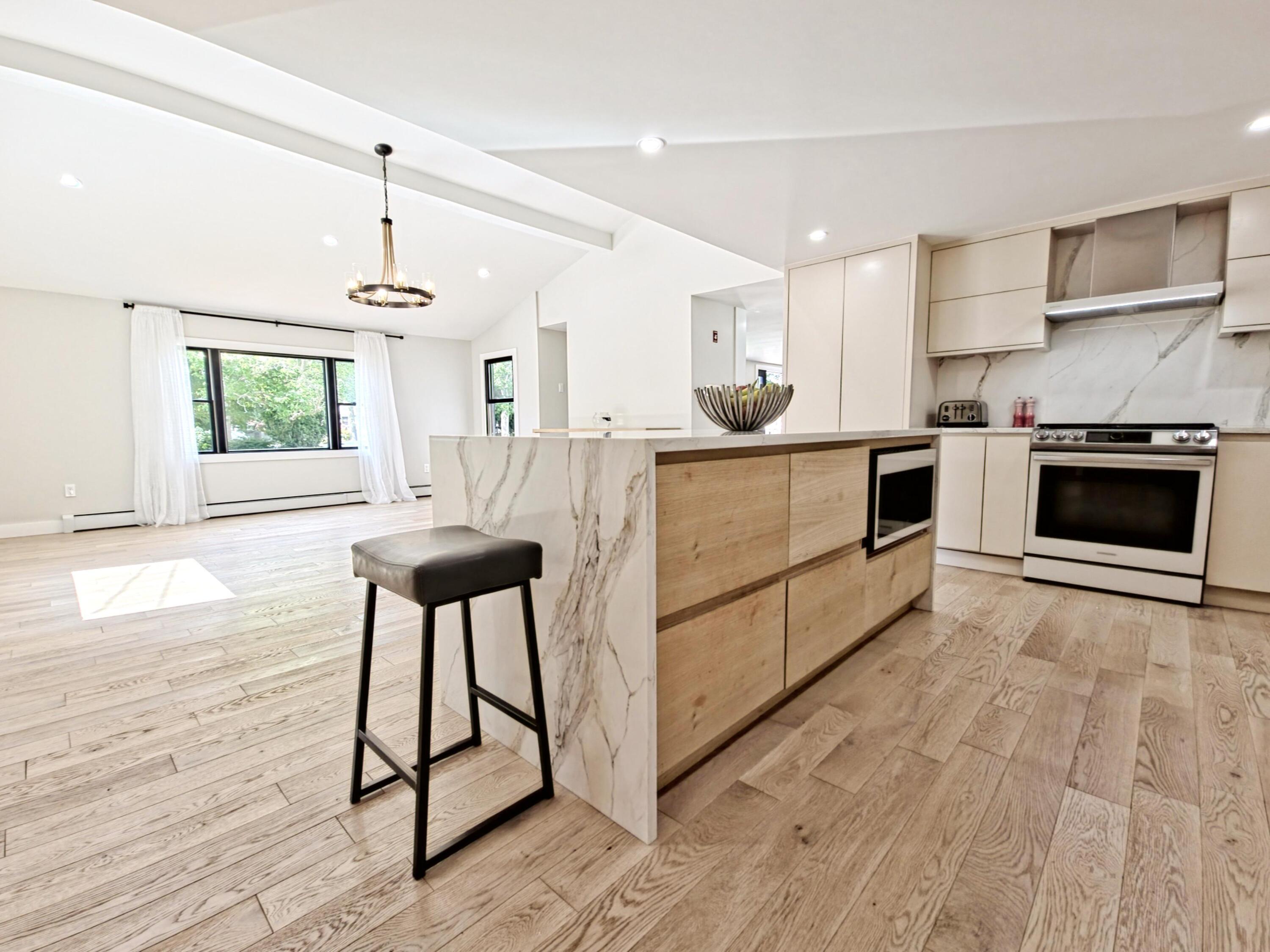 22 Keel Way Hyannis, MA 02601 - Photo 18 of 42 a kitchen with stainless steel appliances a stove a sink cabinets and wooden floor