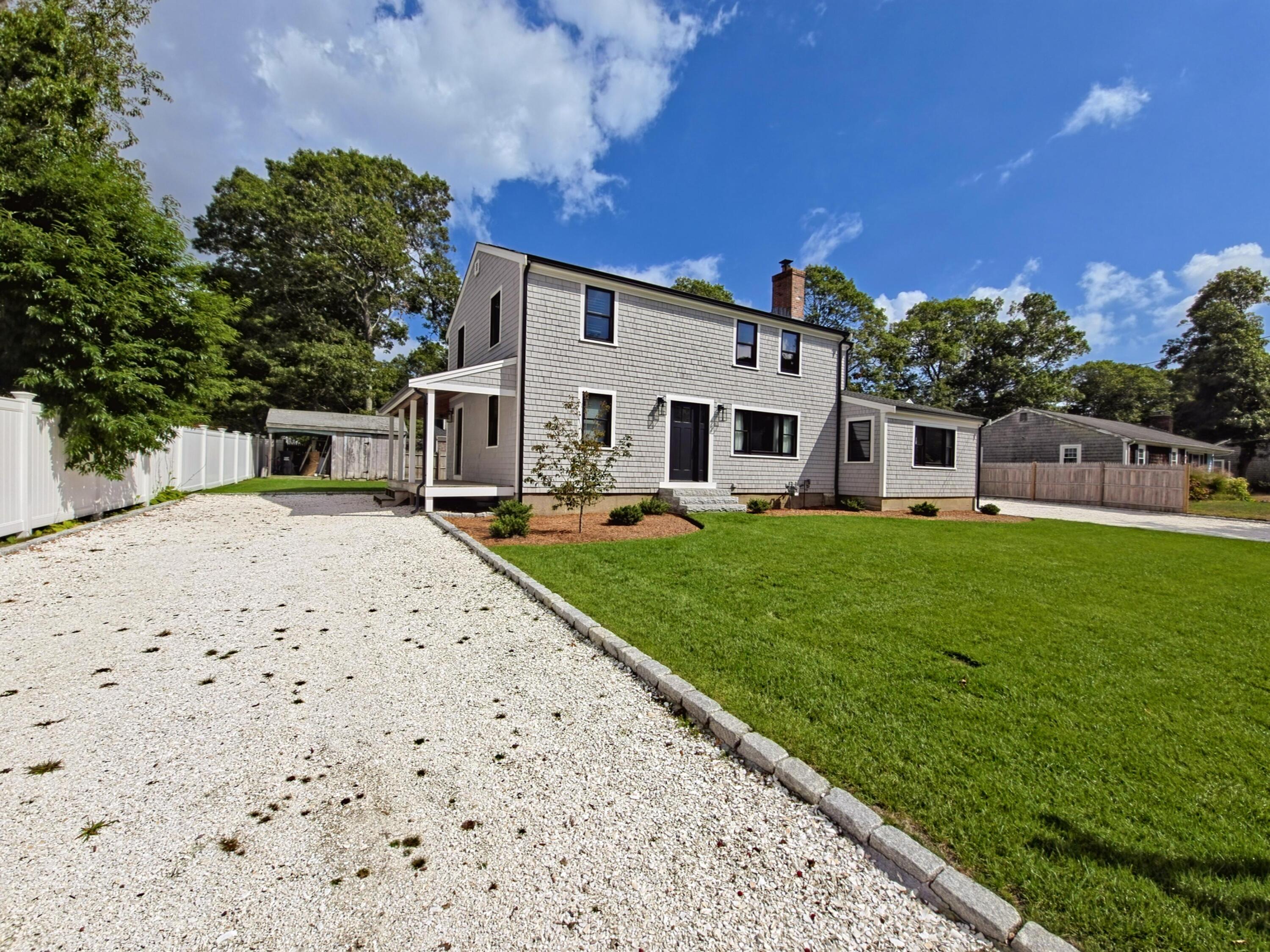 22 Keel Way Hyannis, MA 02601 - Photo 35 of 42 a front view of a house with a garden and trees