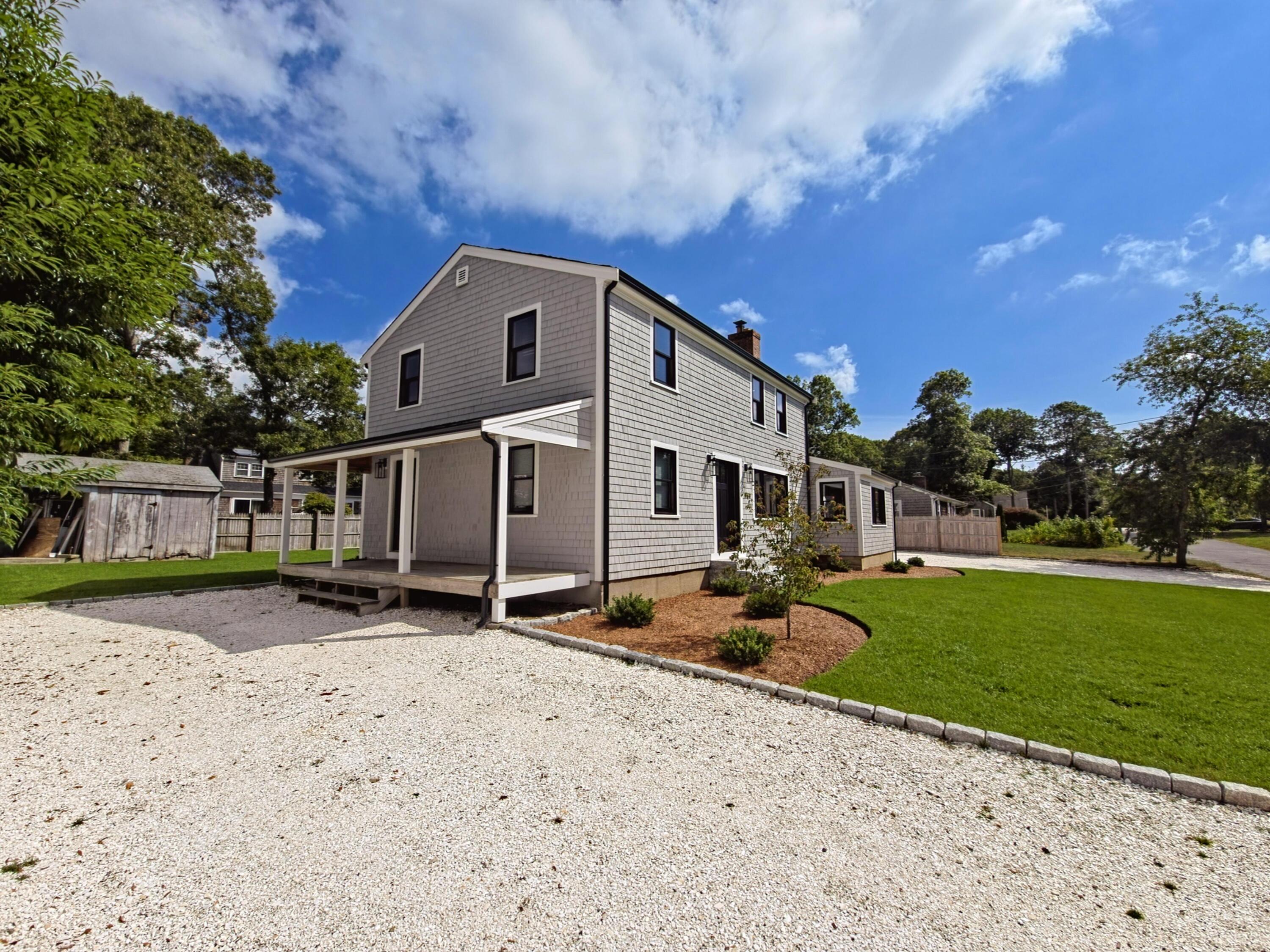 22 Keel Way Hyannis, MA 02601 - Photo 36 of 42 a backyard of a house with table and chairs