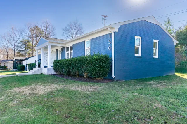 a view of a brick house with a yard