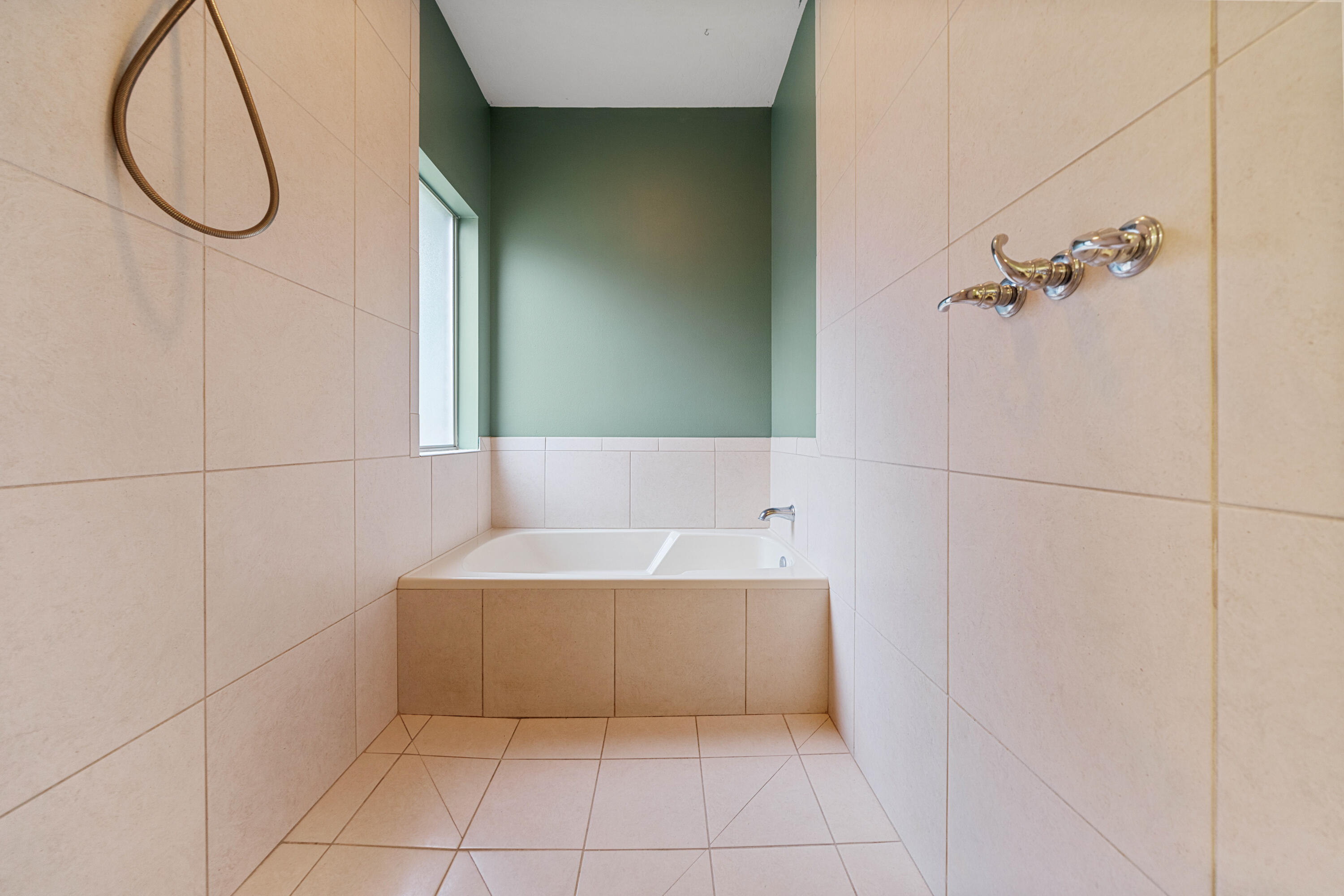 4588 Hermosa Road Crestview, FL 32539 - Photo 21 of 38 a bathroom with a bathtub and a shower