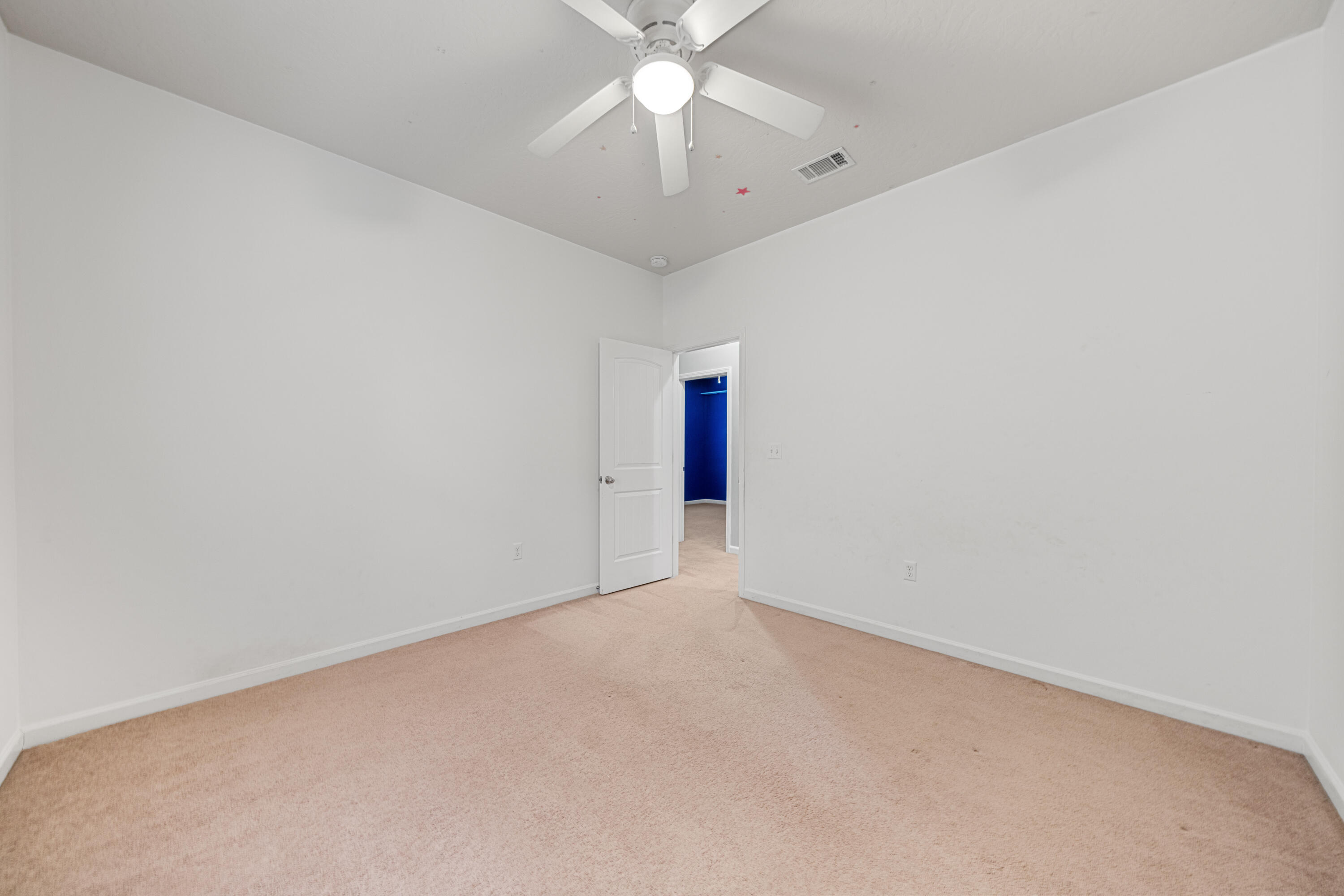 4588 Hermosa Road Crestview, FL 32539 - Photo 25 of 38 an empty room with a chandelier fan and windows