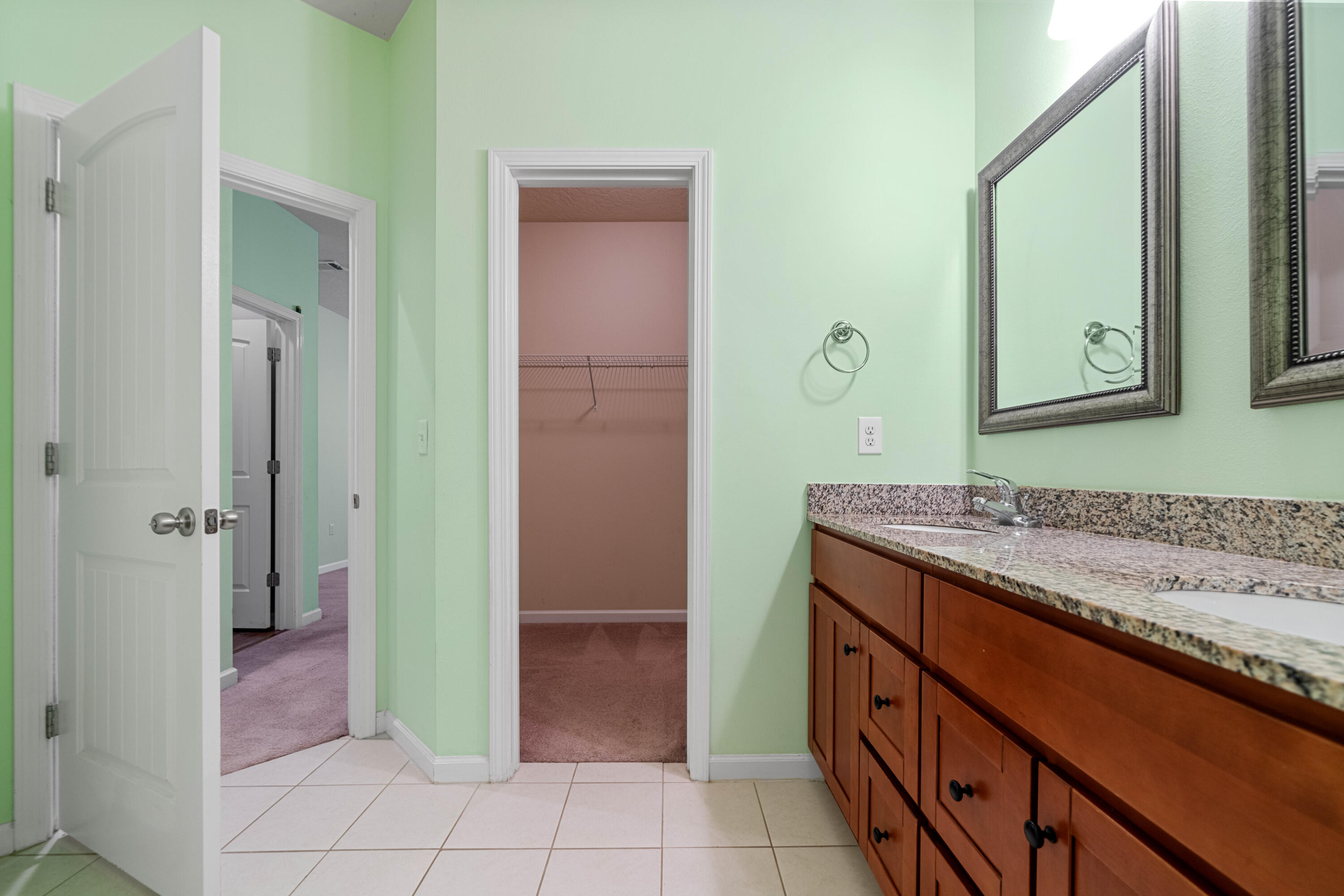 4588 Hermosa Road Crestview, FL 32539 - Photo 33 of 38 a bathroom with a granite countertop sink and a mirror
