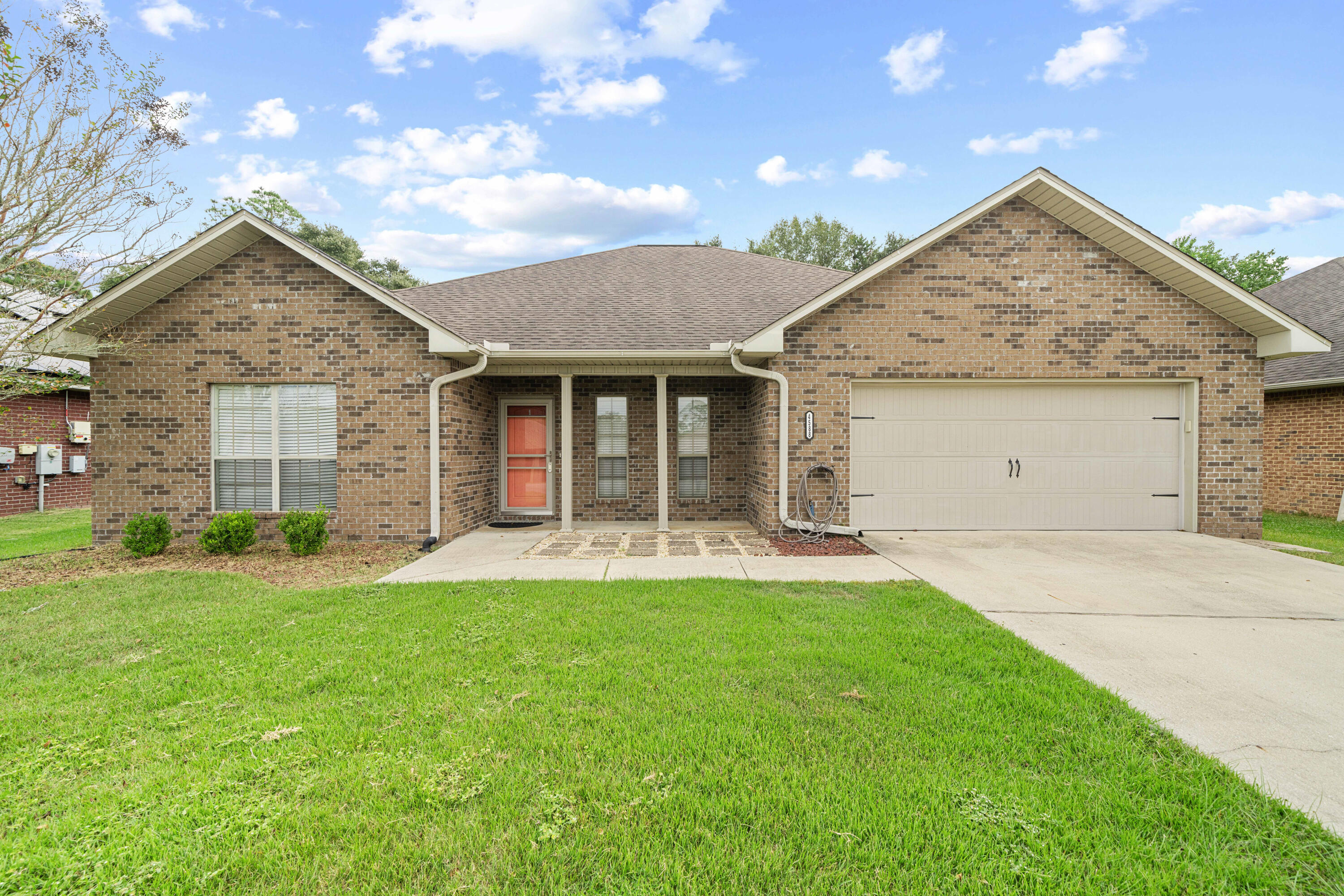 4588 Hermosa Road Crestview, FL 32539 - Photo 35 of 38 a view of a house with a yard and garage