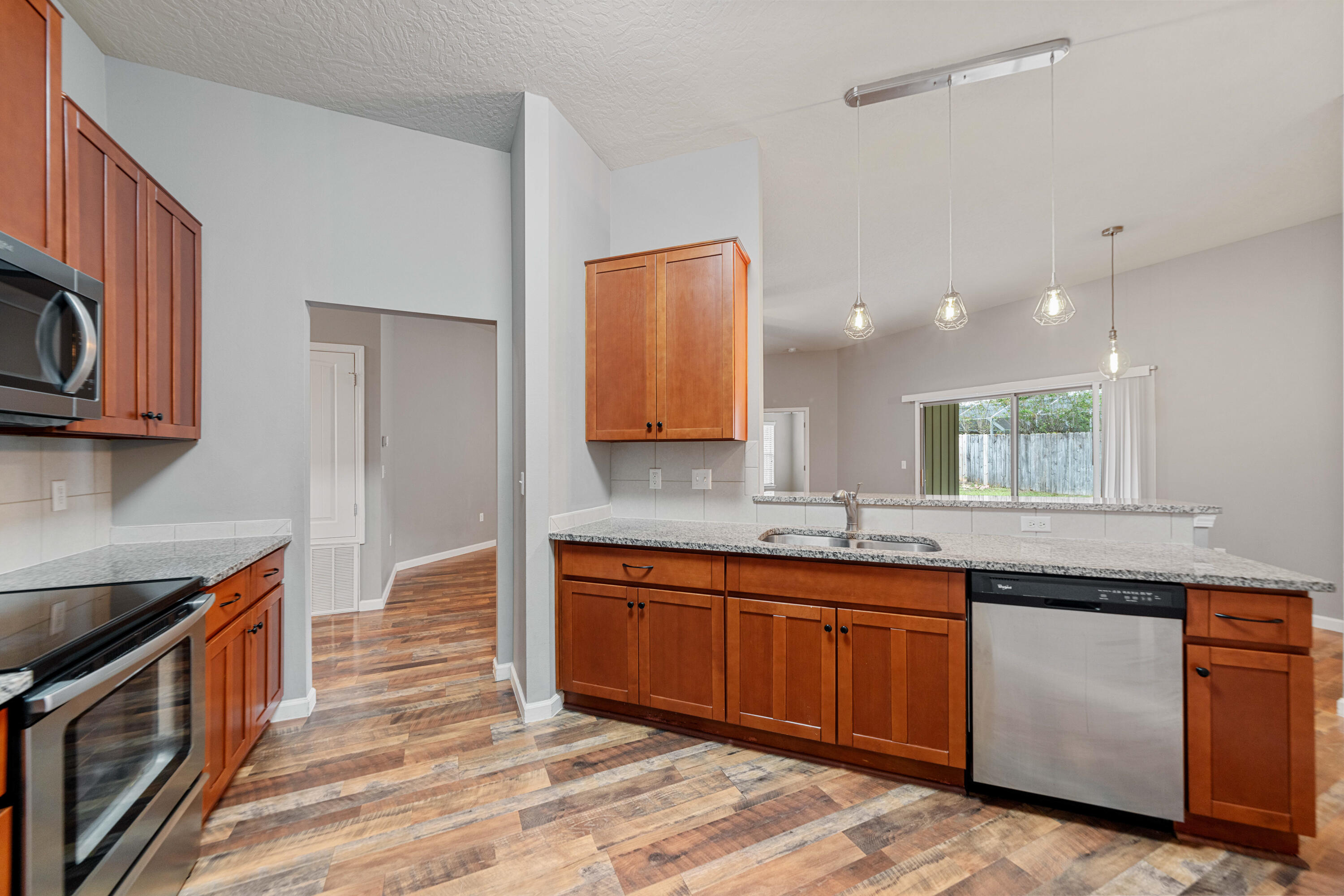 4588 Hermosa Road Crestview, FL 32539 - Photo 7 of 38 a kitchen with lots of counter space and a sink