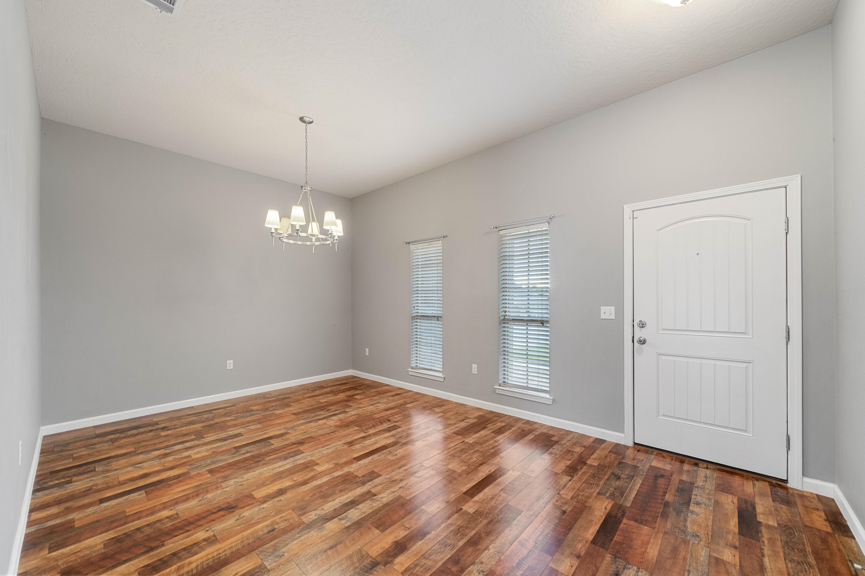 4588 Hermosa Road Crestview, FL 32539 - Photo 9 of 38 a view of empty room with wooden floor and ceiling fan