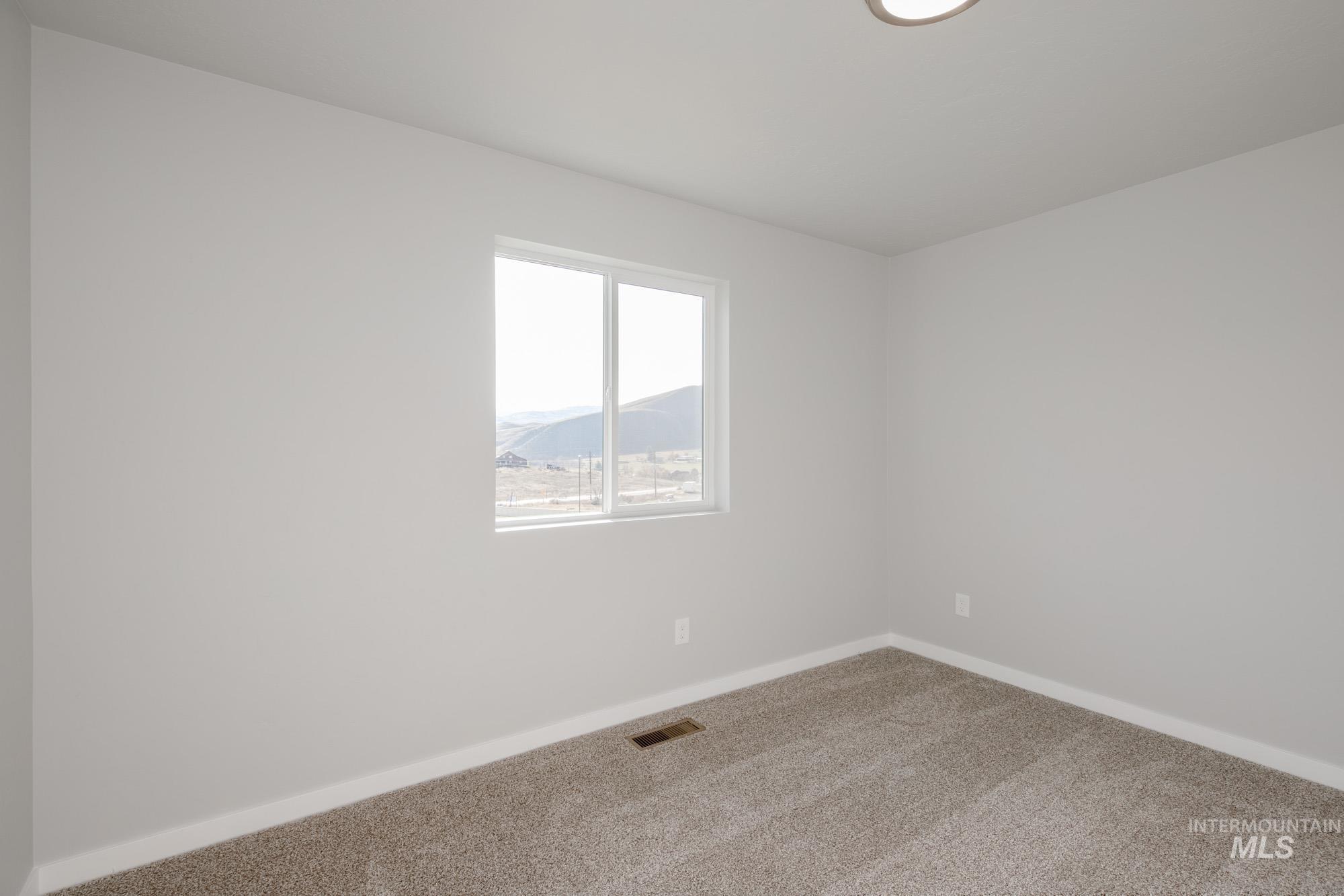 223 Moose Street Horseshoe Bend, ID 83629 - Photo 15 of 23 Empty room featuring baseboards and carpet floors