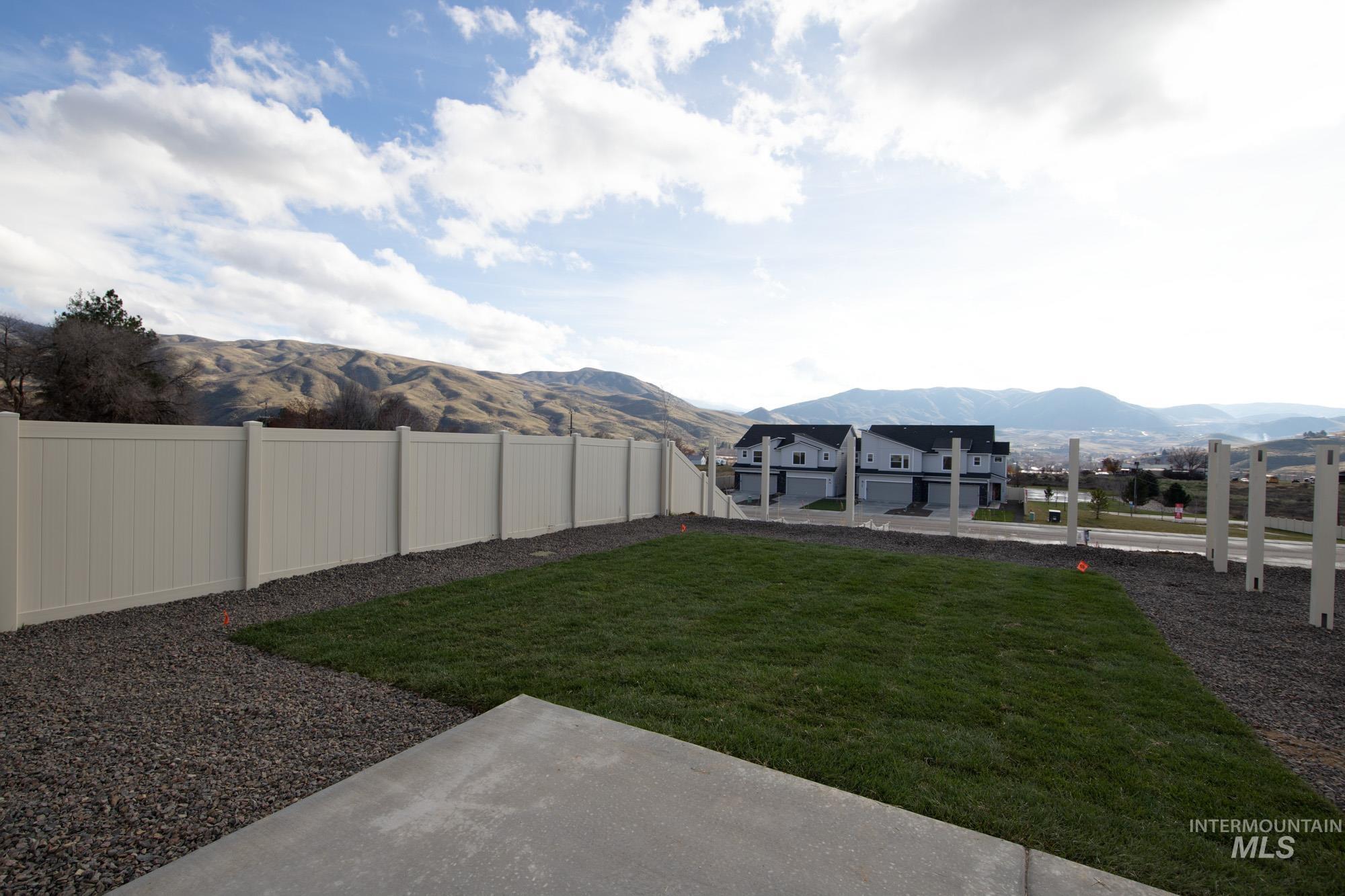 223 Moose Street Horseshoe Bend, ID 83629 - Photo 22 of 23 Fenced backyard with a mountain view and a patio