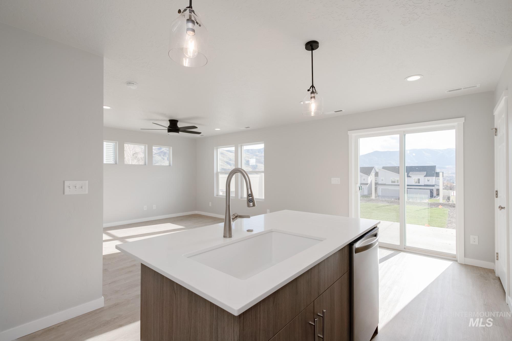 223 Moose Street Horseshoe Bend, ID 83629 - Photo 7 of 23 Kitchen with pendant lighting, ceiling fan, healthy amount of natural light, light wood-type flooring, and recessed lighting