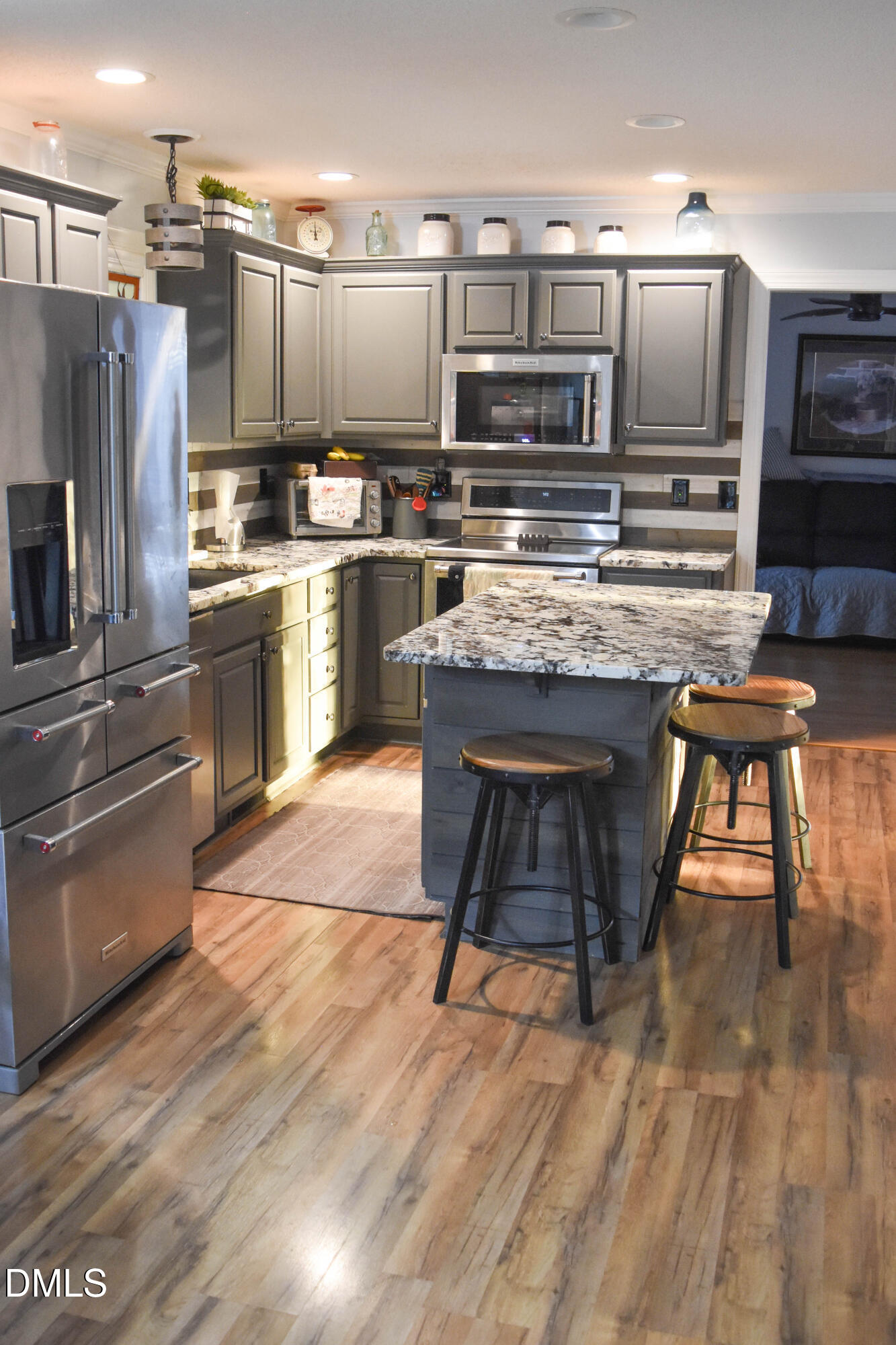 5908 Deep Spring Circle Wake Forest, NC 27587 - Photo 7 of 51 a kitchen with kitchen island stainless steel appliances a stove top oven and refrigerator