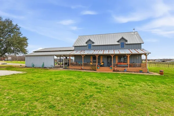 a view of a house with a yard porch and sitting area