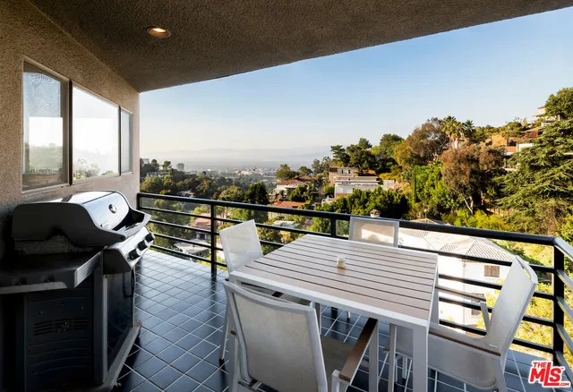 a view of a balcony with chairs