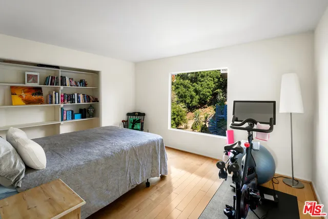 a bedroom with furniture and a window