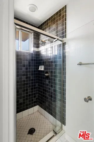 a bathroom with a shower and a sink