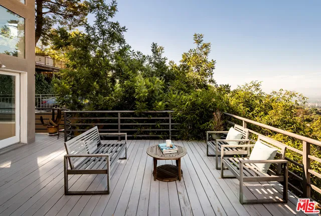 a view of balcony with wooden floor and seating space
