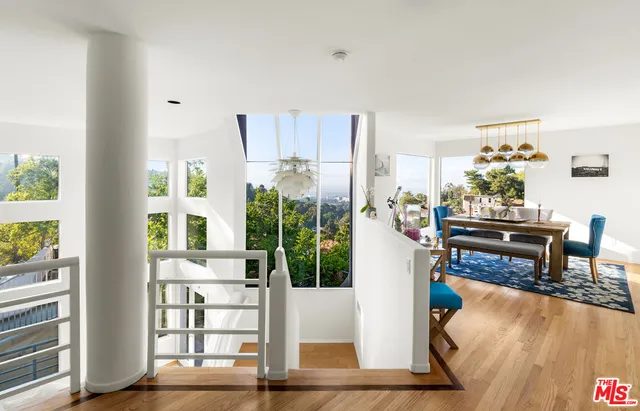 a living room with furniture wooden floor and a table