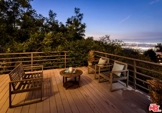 a view of deck with seating area and trees