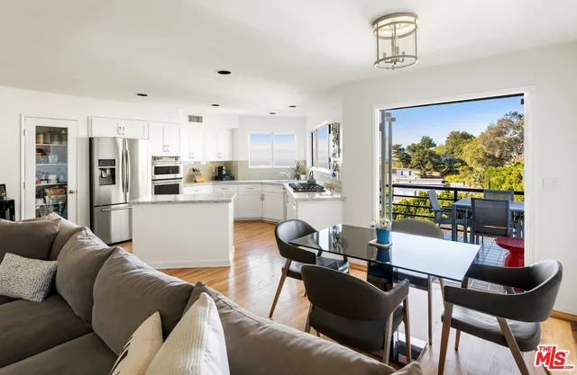a living room with furniture and kitchen view