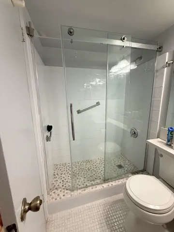 a bathroom with a sink a toilet and mirror