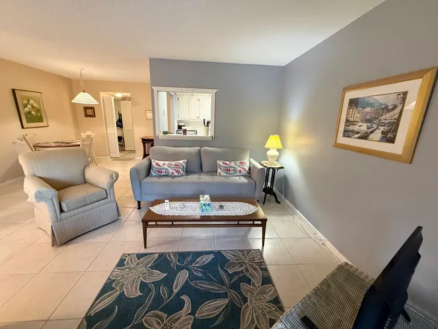 a living room with furniture and a lamp