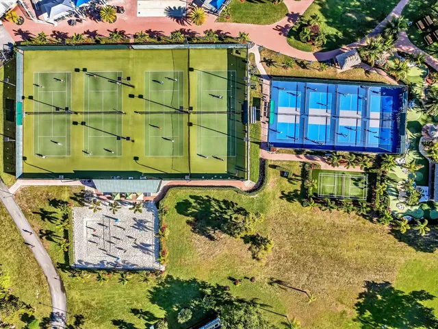 an aerial view of residential houses with outdoor space
