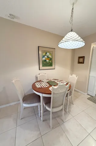 a dining room with a table and chairs