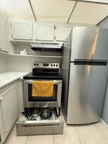 a kitchen with a cabinets and steel appliances