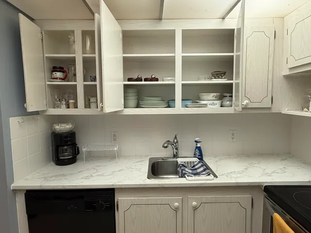 a spacious bedroom with a bed and a chandelier