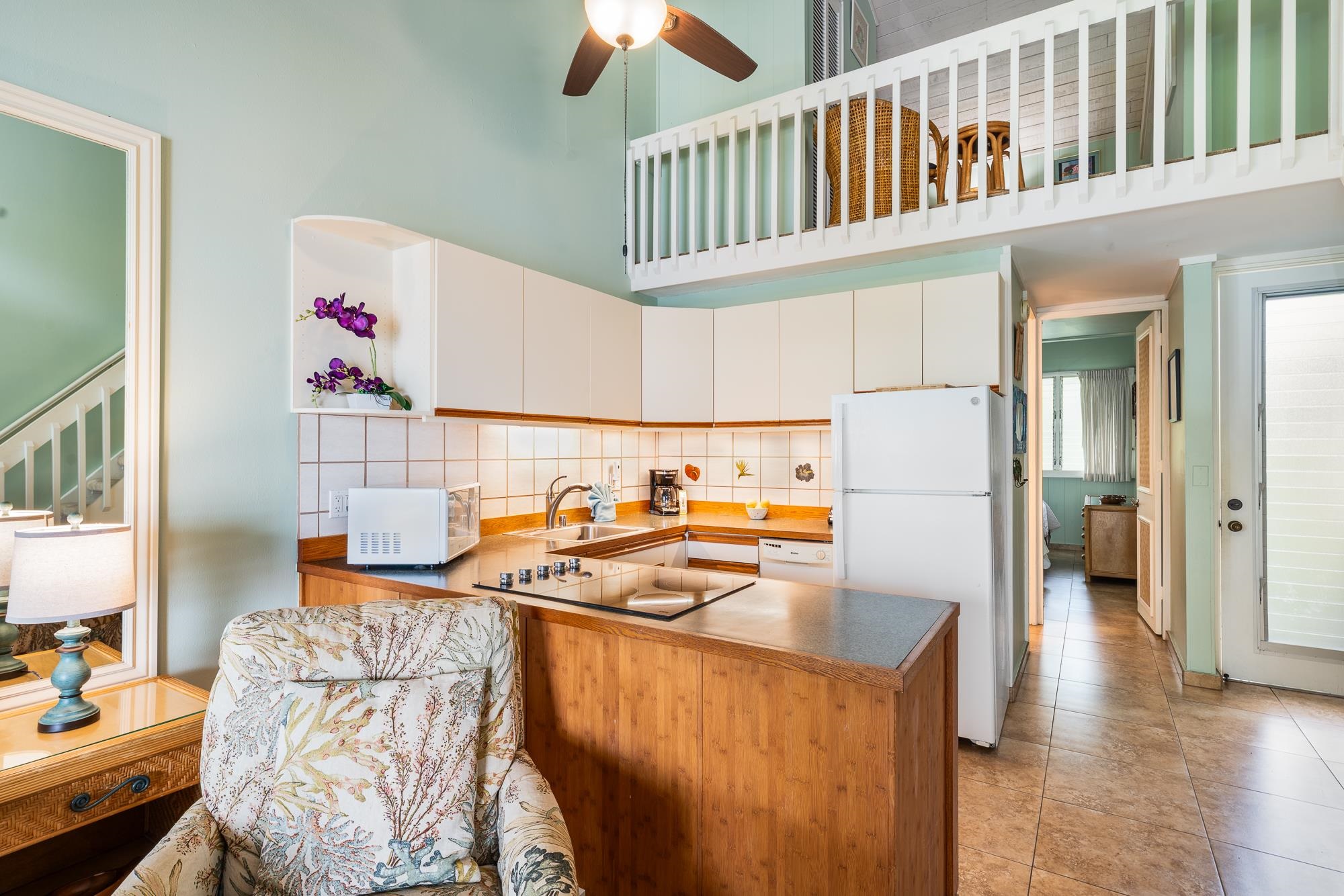 5255 Lower Honoapiilani Road, Unit 207 Lahaina, HI 96761 - Photo 11 of 49 a kitchen that has a cabinets and a table in it